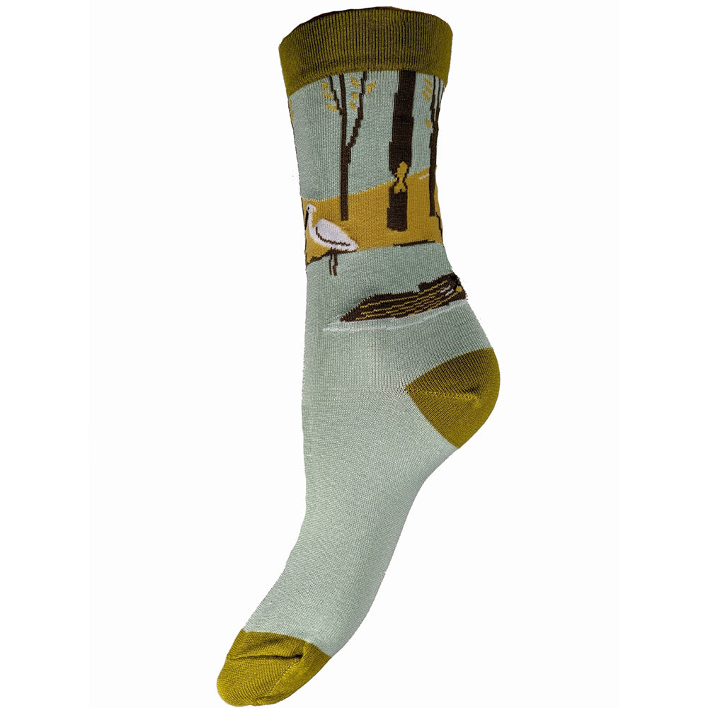 Pale blue bamboo sock with green heel toe and cuff, river bank motif with trees and heron, size 4-7